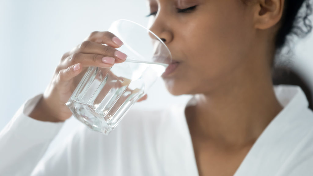 Woman drinking a clean glass of water
